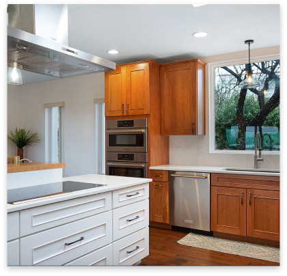 remodeled kitchen with white marble tops and white cabinets.