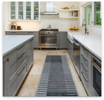 remodeled kitchen with white granite tops and green cabinets.